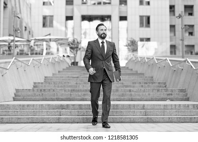 Happy Businessperson Walks Downstairs In Hurry Movement. Young Contemporary Businessman Walking Outdoor In The City ,with Ipad In Hand. Business, Work, Communication Concept.