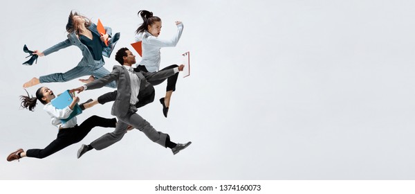 Happy businesswoman and african man dancing in motion isolated on white studio background. Flexibility and grace in business. Human emotions concept. Office, success, professional, happiness - Shutterstock ID 1374160073