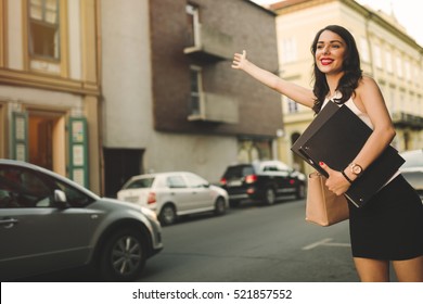 Happy Businesswoman Hailing Cab