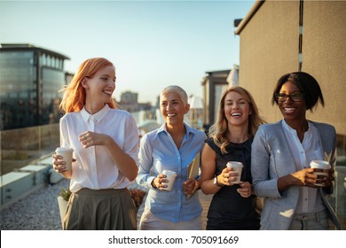 Happy businesswoman having a coffee break together. - Powered by Shutterstock