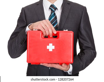 Happy Businesswoman Holding First Aid Box. Isolated On White