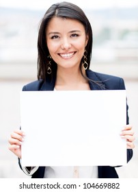 Happy businesswoman holding a white banner and smiling