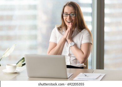 Happy businesswoman laughing with joy at workplace, gladly looking at laptop screen, feeling excited about online win, watching funny video on computer, enjoying positive good news in internet