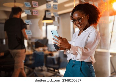 Happy businesswoman in office. Portrait of beautiful businesswoman using the phone. Businesswoman having video call. 
