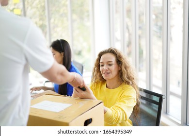 Happy Businesswoman Receiving A Package Sitting On A Desk At Office Delivery Service Concept, Woman Receiving Box From Courier Holding Package Delivering To Customer At Work