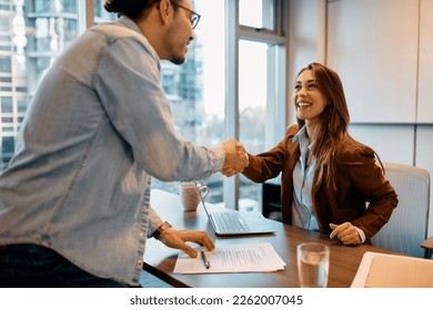 Happy businesswoman shaking hands with job candidate in the office. - Shutterstock ID 2262007045