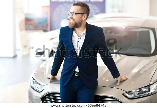 Happy buyer in car\
dealership