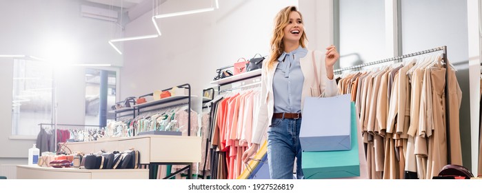 Happy byer with shopping bags standing in showroom, banner  - Shutterstock ID 1927526819