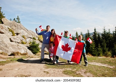 Happy Canada Day. Family With Large Canadian Flag Celebration In Mountains. 