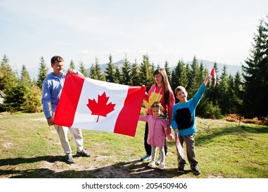 Happy Canada Day. Family With Large Canadian Flag Celebration In Mountains. 