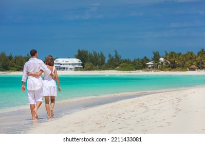 Happy Carefree Male And Female Caucasian Couple In Casual Clothes Outdoors On Tropical Beach Travel Resort For Vacation 