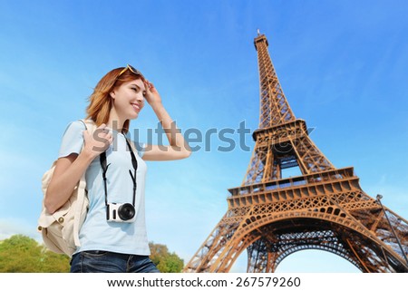Happy carefree travel woman in Paris with Eiffel Tower, caucasian beauty