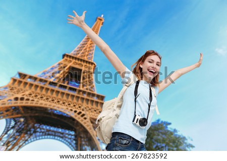 Happy carefree travel woman in Paris with Eiffel Tower, caucasian beauty