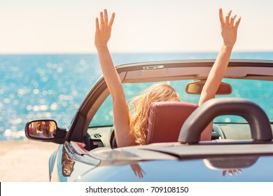 Happy And Carefree Woman In The Car On The Beach