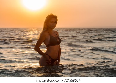 Happy carefree woman on the beach enjoying summer