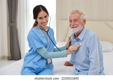 Happy caregiver examining senior elderly man patient listening heartbeat using stethoscope on bed at retirement house. Asian smiling nurse taking good help care and support of elder patient at house. - Powered by Shutterstock