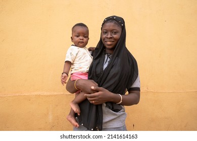 Happy Caring West African Mother Holding Her Cute Little Baby.Motherhood Concept.