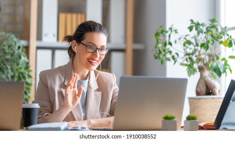 Happy Casual Beautiful Woman Working On A Laptop, Talking With Somebody In Office.