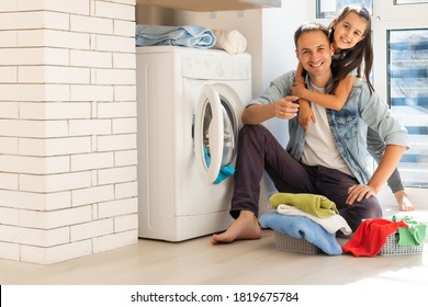 Happy Casual Multiethnic Family Laundry Clothes At Home