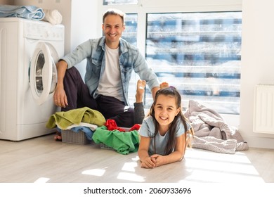 Happy Casual Multiethnic Family Laundry Clothes At Home