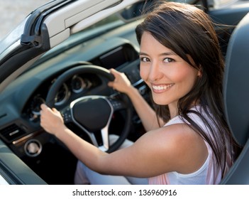 Happy Casual Woman Driving A Convertible Car