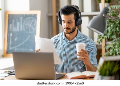 Happy Casual Young Man Working On A Laptop At Home.