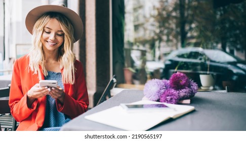 Happy Caucaisan customer resting at street terrace using smartphone technology for writing web review about floristic delivery, cheerful hipster girl connecting to 4g wireless for browsing website - Shutterstock ID 2190565197