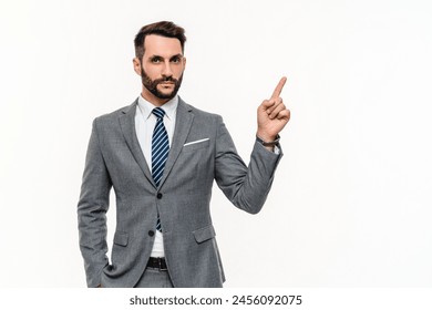 Happy Caucasian businessman in formal attire posing with pointing finger isolated over white background. Cheerful bank manager accountant showing free space promotion blank space - Powered by Shutterstock