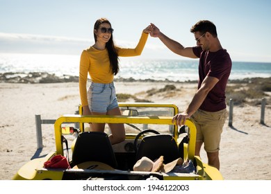 Happy caucasian couple in beach buggy by the sea holding hands. beach break on summer holiday road trip. - Powered by Shutterstock