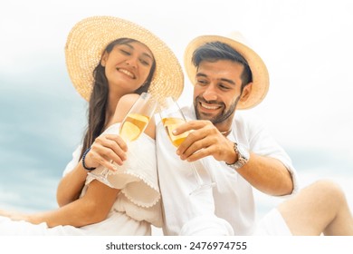 Happy Caucasian couple enjoy outdoor lifestyle travel at the sea on summer beach vacation. Man and woman celebration holiday event drinking champagne together at tropical island beach at sunset.  - Powered by Shutterstock