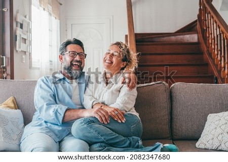 Similar – Image, Stock Photo Joyful couple laughing together on a vintage sofa