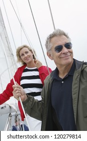 Happy Caucasian Couple Looking Away On Sail Boat