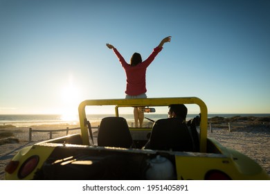 Happy caucasian couple on beach during sunset woman sitting on beach buggy man sitting in. beach break on summer holiday road trip. - Powered by Shutterstock