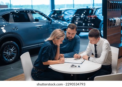 Happy caucasian couple signs contract for the purchase car salon 