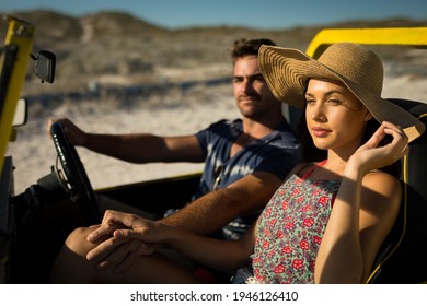 Happy caucasian couple sitting in beach buggy by the sea holding hands. beach break on summer holiday road trip. - Powered by Shutterstock