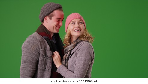Happy Caucasian Couple Standing Together In Winter Attire On Green Screen