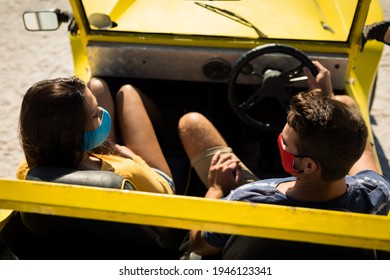 Happy caucasian couple wearing face masks sitting in beach buggy. beach stop off on summer holiday road trip during coronavirus covid 19 pandemic. - Powered by Shutterstock