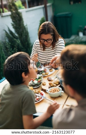 happy caucasian family eats together in home backyard