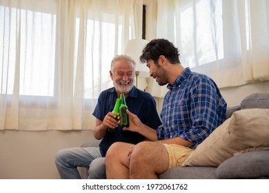 Happy Caucasian family senior father and adult son watching sport game on TV with drinking beer together in home living room. Excited dad and son sport fans cheering sports team for winning the match.