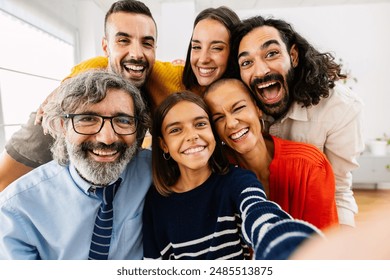 Happy caucasian family talking selfie portrait together at home. Multigenerational group of people smiling at camera standing gathered at domestic room. - Powered by Shutterstock