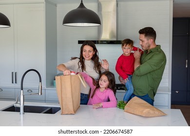 Happy Caucasian Family Unpacking Groceries Together In Kitchen. Family Time, Having Fun Together At Home.