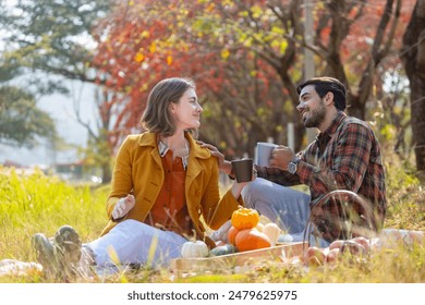 Happy caucasian farmer couple have picnic dating from organics homegrown harvest like apple, squash and pumpkin with fall color from maple tree during autumn season - Powered by Shutterstock