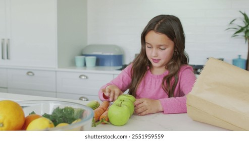 Happy caucasian girl unpacking groceries in kitchen. childhood, leisure and spending quality time at home. - Powered by Shutterstock