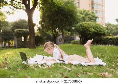 happy caucasian kid has online lesson on laptop during coronavirus covid-19 pandemic and lockdown - Powered by Shutterstock