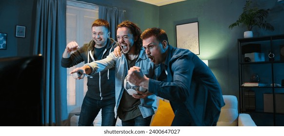 Happy Caucasian male football fans friends standing in front of TV screen in dark living room on vouch and watching match Euro2024. Scoring goal or winning game concept. Cheerful men celebrating win. - Powered by Shutterstock