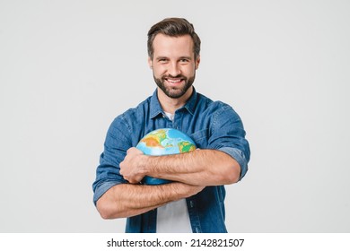 Happy caucasian male traveler holding hugging embracing planet globe Earth for nature protection, traveling isolated in white background