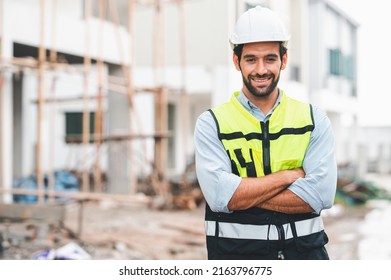 Happy Caucasian Man Construction Site Manager Smiling With Confident Standing Arms Crossed Wearing Safety Vest And Helmet At Construction Site. 