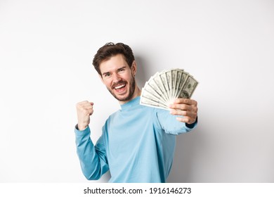 Happy Caucasian Man Stretch Out Hand With Money In Dollars, Saying Yes And Celebrating Income, Got Cash Prize, Standing Over White Background