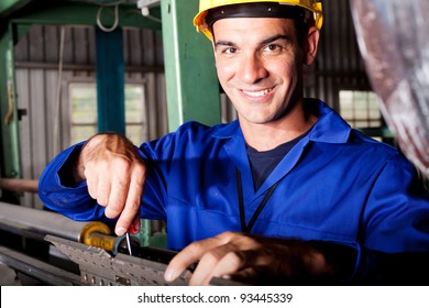 Happy Caucasian Mechanic Repairing Heavy Industry Machine