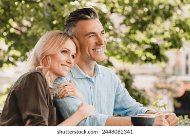 Happy caucasian middle-aged spouses couple hugging embracing bonding and drinking coffee in cafe restaurant together on a date. Love and relationship concept. - Powered by Shutterstock